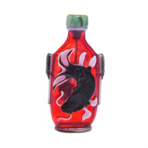 Glass red with double overlay of black and white the layers carved through to show a carp