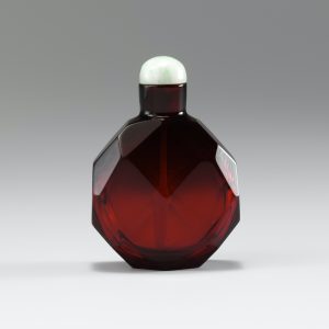 Deep red glass of multi-faceted form