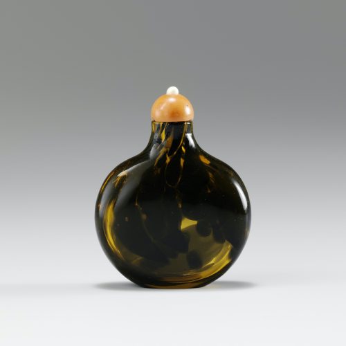 Dark brown dapples with pale brownish-orange glass of flattened form