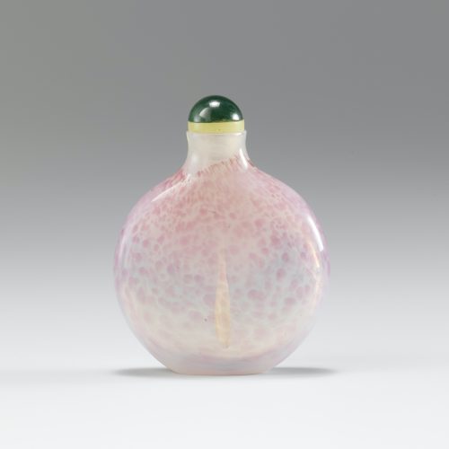 Pink dapples on white glass of flattened form