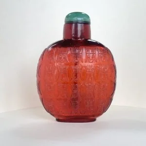 Glass ruby red, carved in low relief