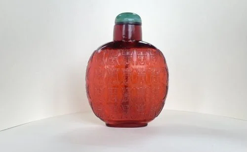 Glass ruby red, carved in low relief
