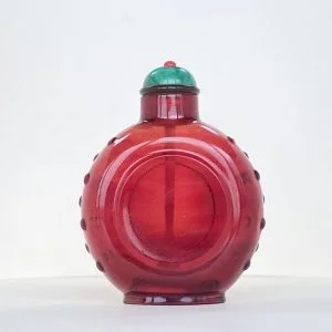 Glass ruby red, of small size with circular panel