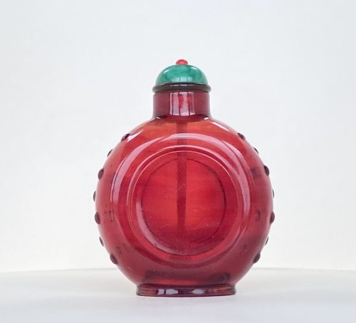 Glass ruby red, of small size with circular panel